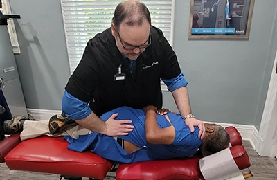 Chiropractor Greensboro NC Shane Cobb Adjusting Patient