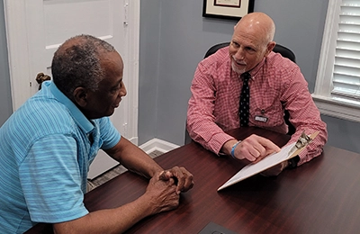 Chiropractor Greensboro NC Steven Rubin Consulting With Patient