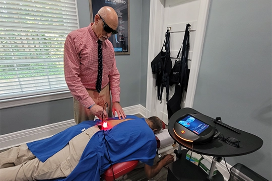 Chiropractor Greensboro NC Steven Rubin Using Laser Machine