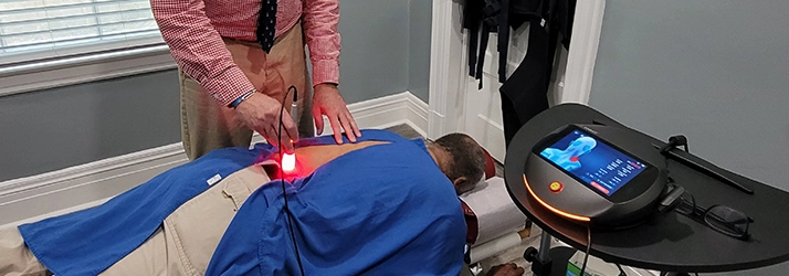 Chiropractor Greensboro NC Steven Rubin With Laser Therapy Patient